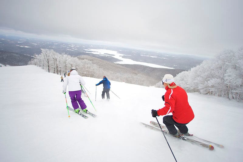 People skiing down hill.